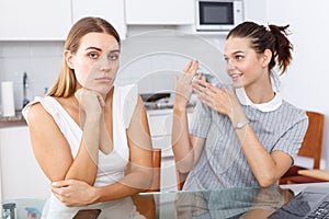 Young girl showing betrothal ring to upset female friend