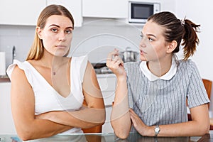 Young girl showing betrothal ring to upset female friend