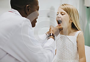 Young girl showing a dentist her teeth photo