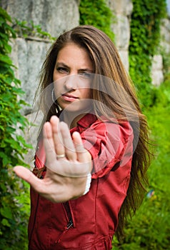 Young girl showing stop sign