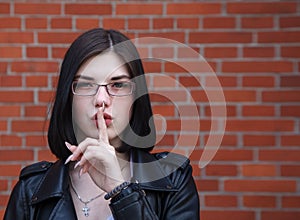 Young girl shows a gesture quietly