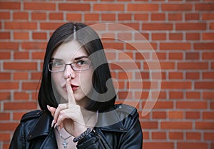 Young girl shows a gesture quietly