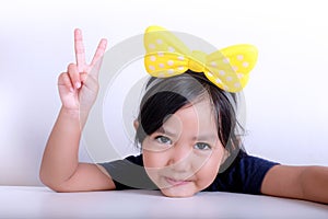 Young girl shows peace hand sign