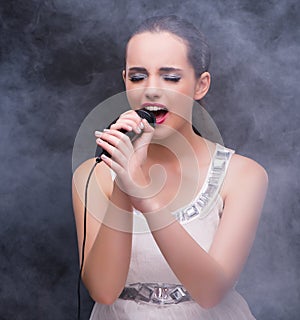 Young girl singing in karaoke club