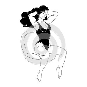 Young girl sits in a black bathing suit, combing long black hair