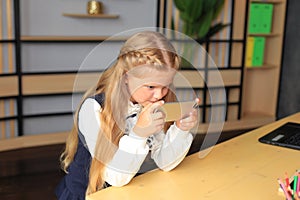 A young girl sits at a computer in the office.