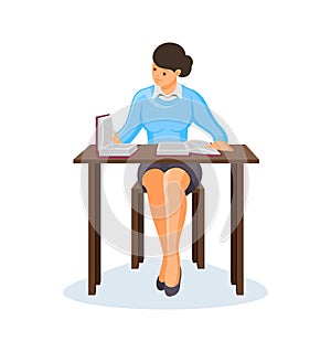 Young girl sits at a table studying books.