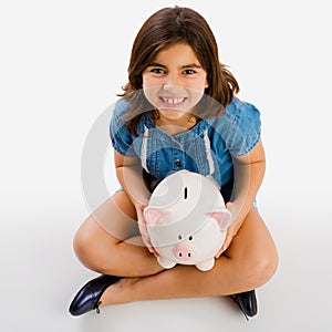 Young girl holding a piggybank