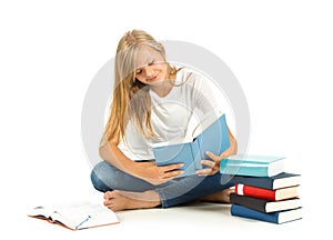 Young girl sitting on the floor reading over white background