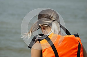 Young girl sitting in a life jacket for safety