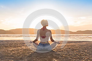 Young Girl Sitting Lotus Pose On Beach At Sunset, Beautiful Woman Practicing Yoga Summer Vacation Meditation Seaside