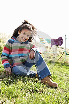 Young Girl Sitting Outside In Caravan Park