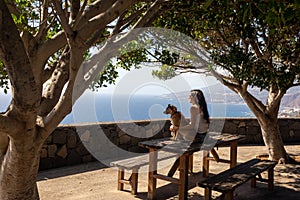 Young girl sitting on a picnic table