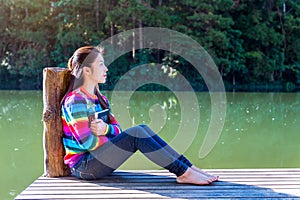 Young girl sitting on a pier.