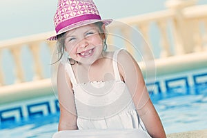 Young Girl Sitting by the Pool