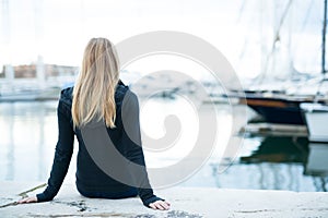 Young girl sitting in the port