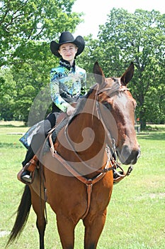 Young girl sitting on a quarterhorse