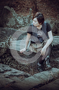 Young girl sitting on rocks outdoors in New York City