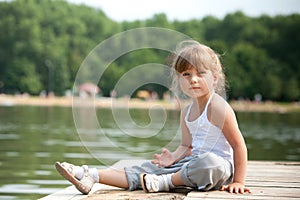 Young girl sitting sitting in a pier