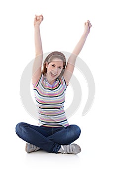 Young girl sitting in tailor seat shouting happily