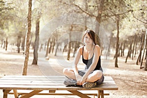 Young girl sitting on a wooden table