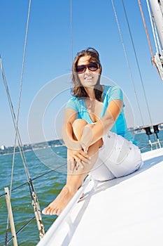 Young girl sitting on a yacht