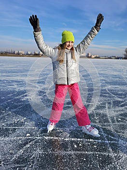 Young girl skate on lake in winter