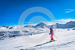 Young girl skiing down on a ski slop in Andorra, Pyrenees Mountains