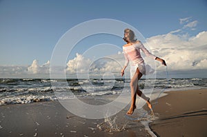 Young girl skipping on the beach