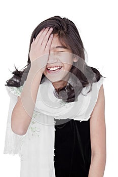 Young girl slapping herself on the head, laughing