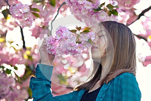 Young girl smelling blossoms