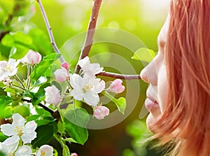 Young girl smelling blossoms