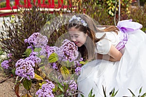 Young girl smelling flowers