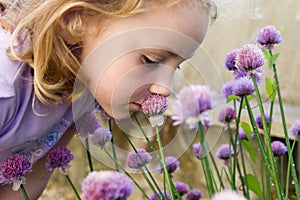 Young girl smelling flowers