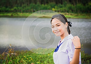 Young girl smile in contryside nature and river in evening light