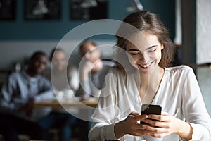 Young girl smiling feeling attention from flirting guys in cafe