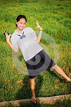 Young girl smiling in meadow contryside nature in evening light