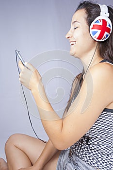Young girl smiling with phone and headphones photo