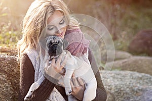 Young girl smiling with pug dog
