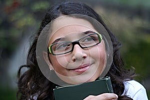Young girl smiling wearing green glasses