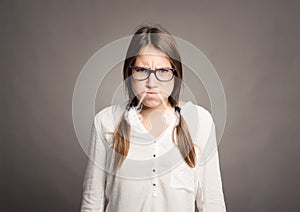 Young girl with smoke on her nose with angry expression