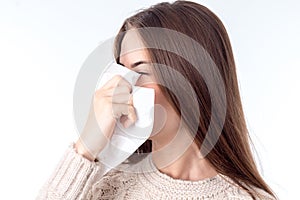 Young girl with sniffles wipes nose isolated on white background photo