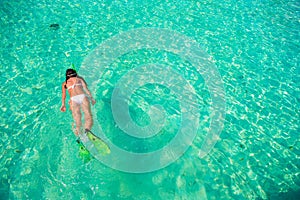 Young girl snorkeling in tropical water on