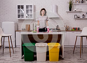 Young girl sorting garbage at the kitchen. Concept of recycling. Zero waste