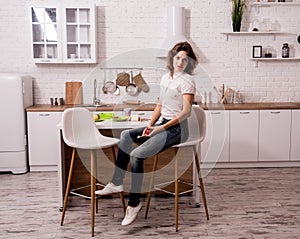 Young girl sorting garbage at the kitchen. Concept of recycling. Zero waste