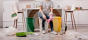 Young girl sorting garbage at the kitchen. Concept of recycling. Zero waste