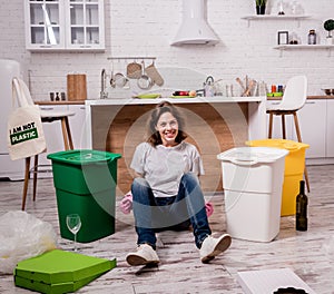 Young girl sorting garbage at the kitchen. Concept of recycling. Zero waste