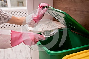 Young girl sorting garbage at the kitchen. Concept of recycling. Zero waste