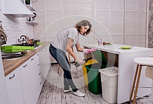 Young girl sorting garbage at the kitchen. Concept of recycling. Zero waste