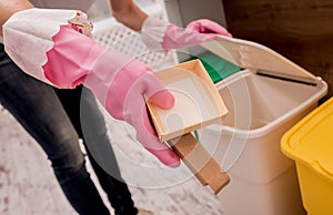 Young girl sorting garbage at the kitchen. Concept of recycling. Zero waste